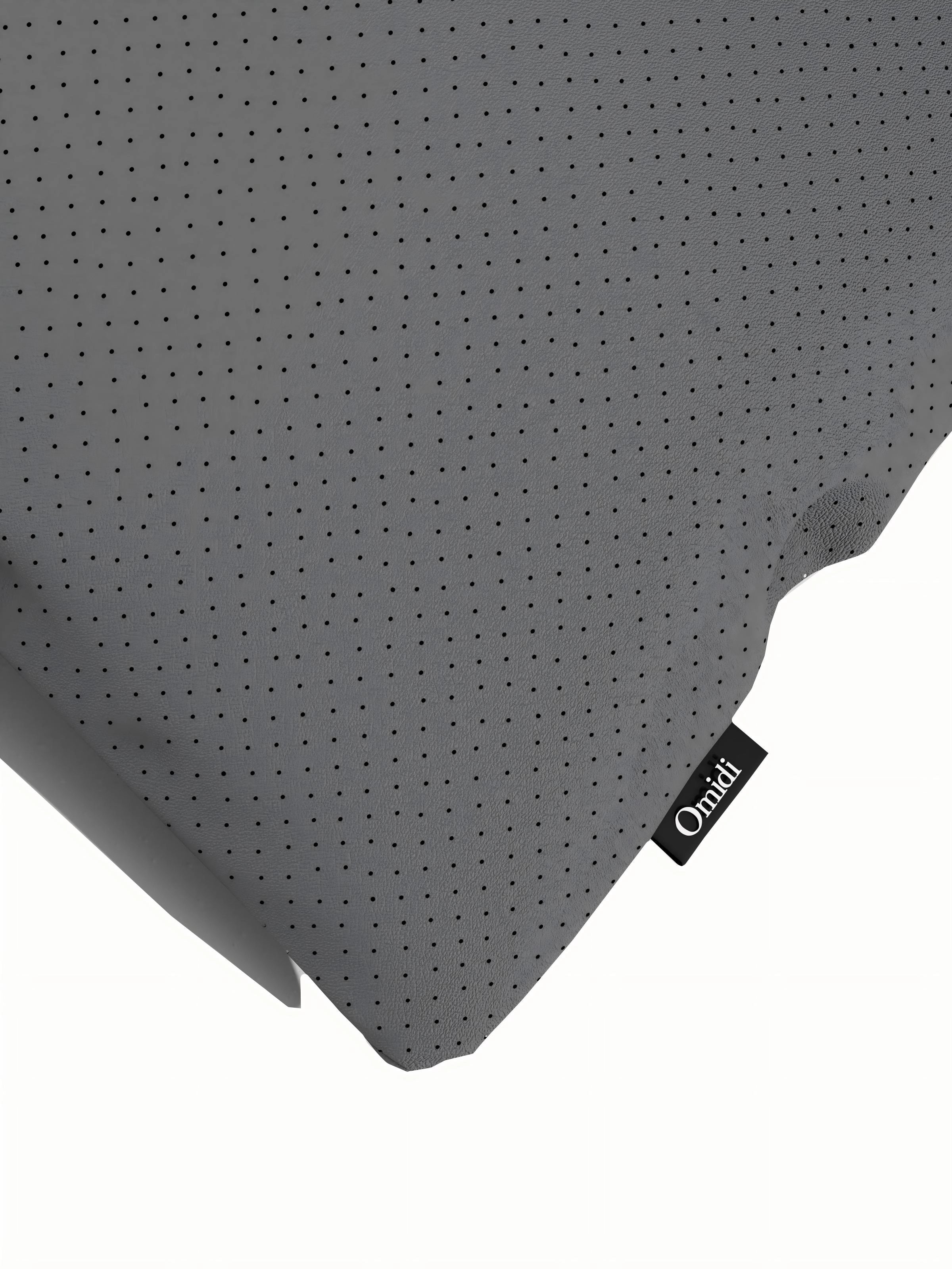Beige full-grain leather cushion with dotted texture and side tag