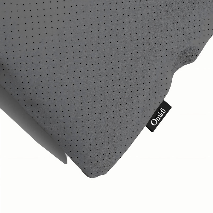 Black perforated leather cushion with corner tag