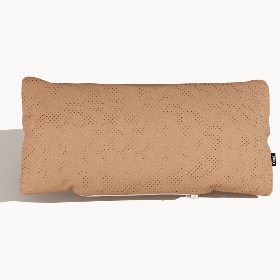 Tan full-grain leather cushion with dotted texture and side tag